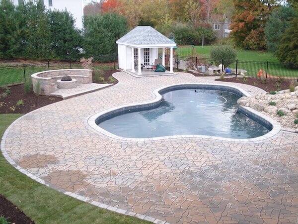 Pool with a fire pit, poolhouse, patio, and landscaping